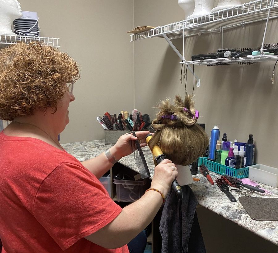 Amy Salzstein styling a hair piece at the Hair Response studio
