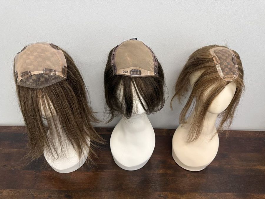 Hair toppers displayed on forms at Hair Response
